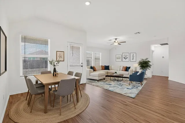 a view of a dining room with furniture and wooden floor