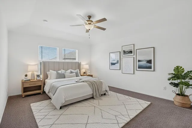 a bedroom with a bed and a potted plant