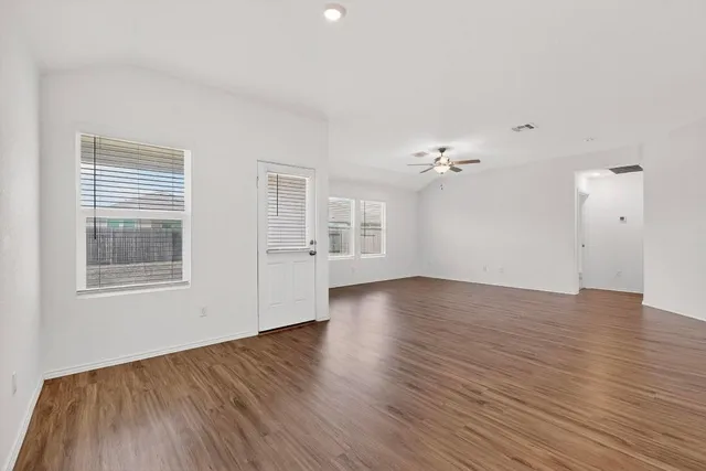 wooden floor in an empty room with a window