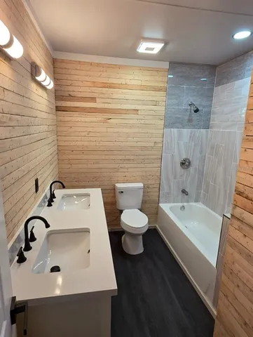 a view of a hallway with wooden floor and a window