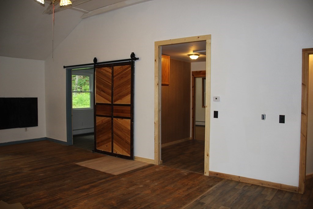 250 S Road Heath, MA 01346 - Photo 14 of 28 an empty room with wooden floor wooden cabinet and windows