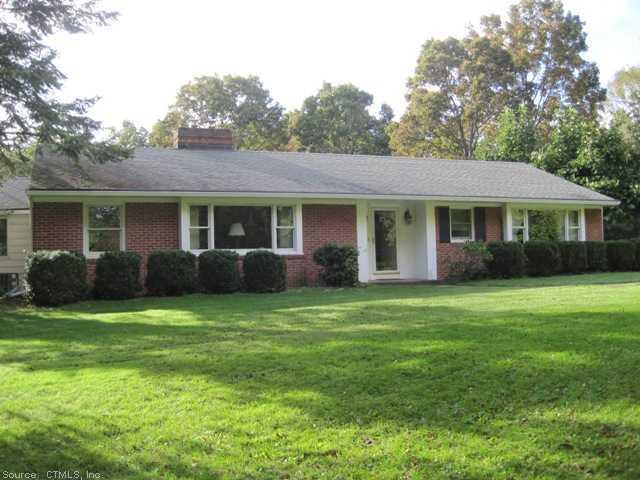 1146 Johnson Road Woodbridge, CT 06525 - Photo 1 of 1 a front view of a house with a garden