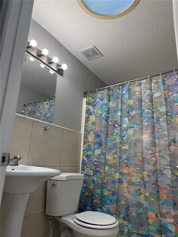 a view of a hallway with wooden cabinets