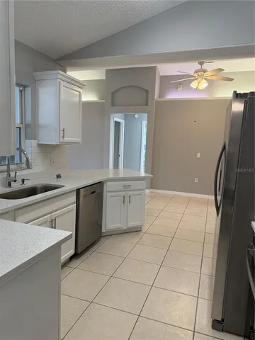 a kitchen with a sink cabinets and appliances