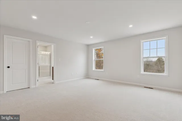 an empty room with windows and closet