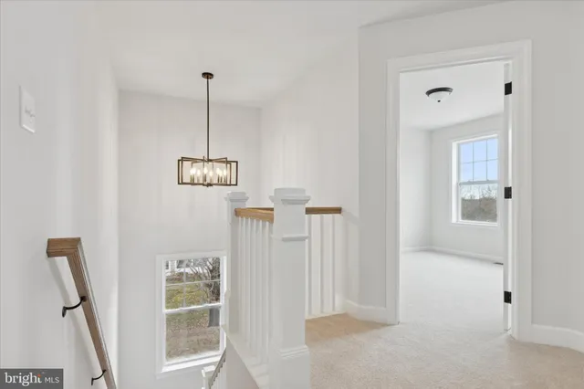 a view of a hallway with windows and entryway