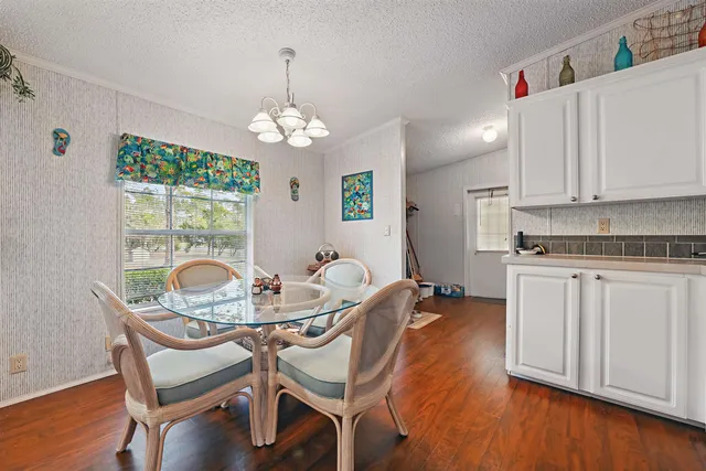 a dining room with furniture and a chandelier