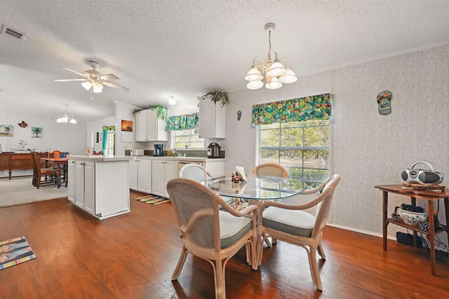 a dining room with furniture a rug and a chandelier