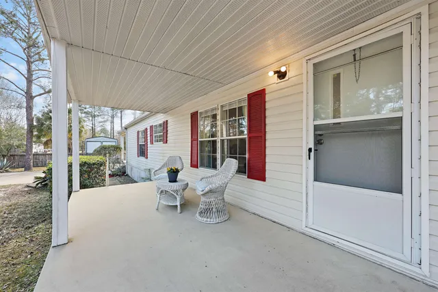 a view of a patio with table and chairs and potted plants
