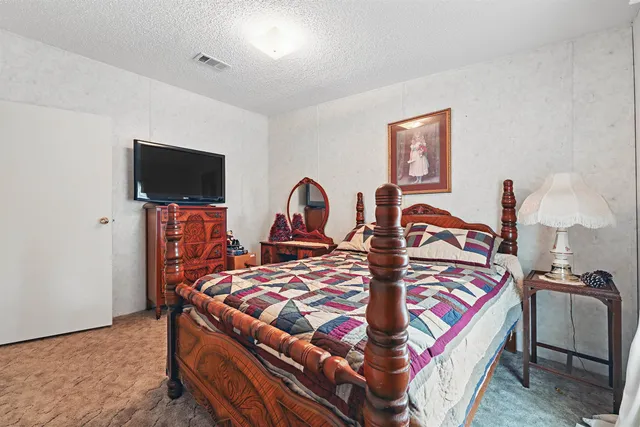 a bedroom with a bed and a table