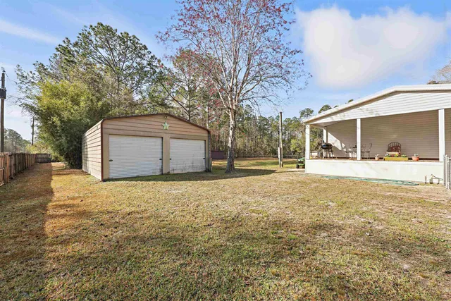 a view of a yard with large trees