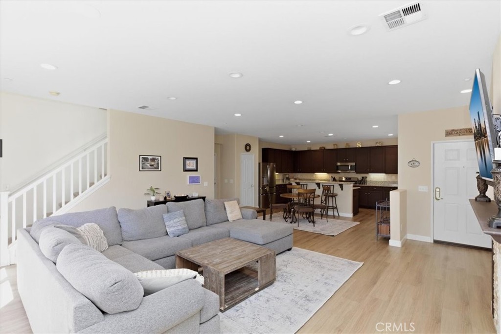 7353 Ellena West, Unit 70 Rancho Cucamonga, CA 91730 - Photo 11 of 40 a living room with furniture and wooden floor