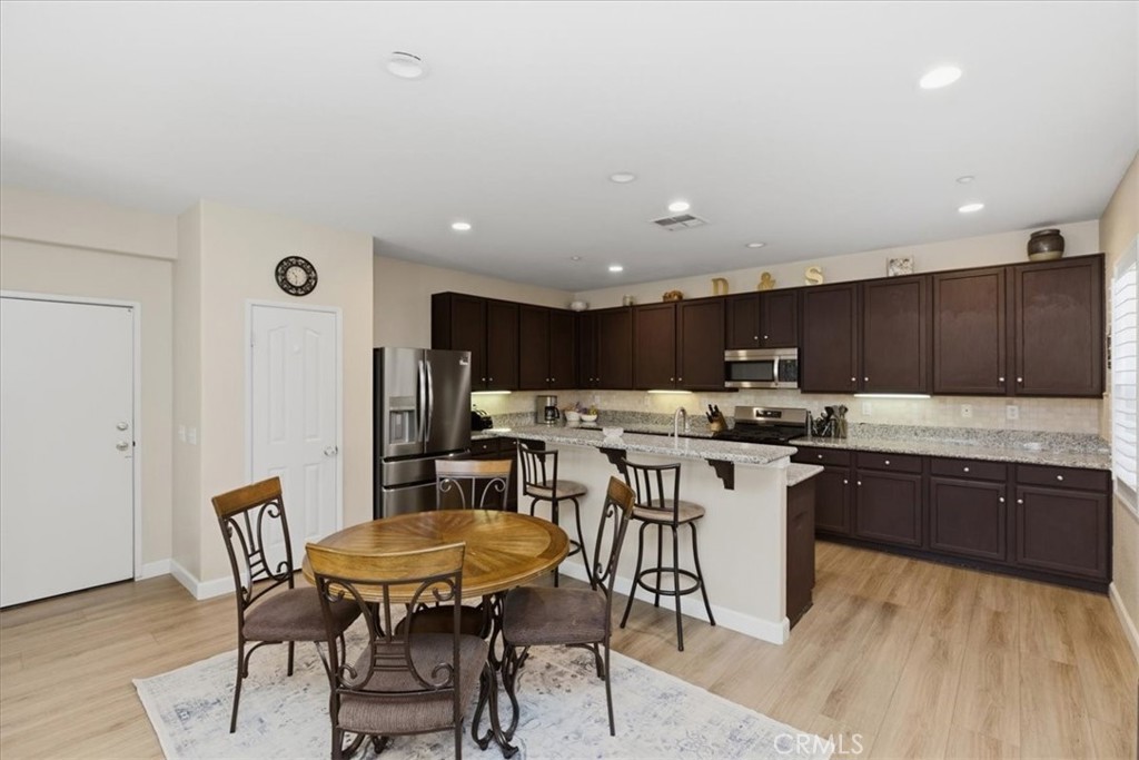 7353 Ellena West, Unit 70 Rancho Cucamonga, CA 91730 - Photo 13 of 40 a kitchen with a table and chairs in it