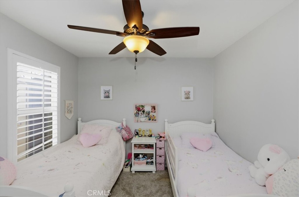7353 Ellena West, Unit 70 Rancho Cucamonga, CA 91730 - Photo 24 of 40 a bedroom with a bed and a chandelier