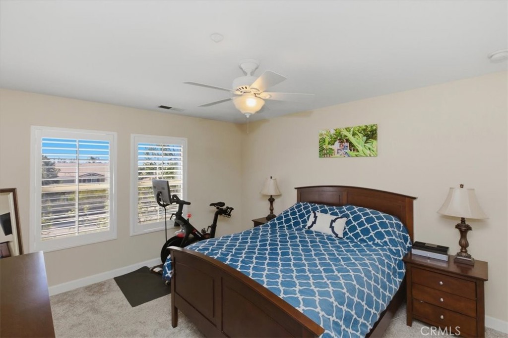 7353 Ellena West, Unit 70 Rancho Cucamonga, CA 91730 - Photo 28 of 40 a bedroom with bed and window