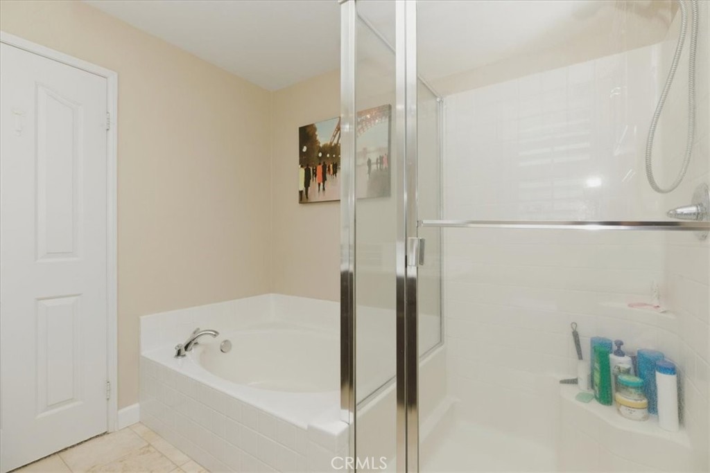7353 Ellena West, Unit 70 Rancho Cucamonga, CA 91730 - Photo 30 of 40 a bathroom with a tub and shower