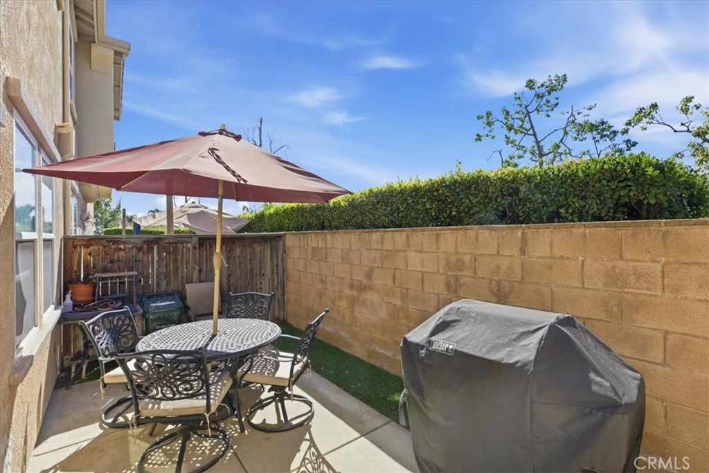 7353 Ellena West, Unit 70 Rancho Cucamonga, CA 91730 - Photo 32 of 40 a backyard of a house with table and chairs
