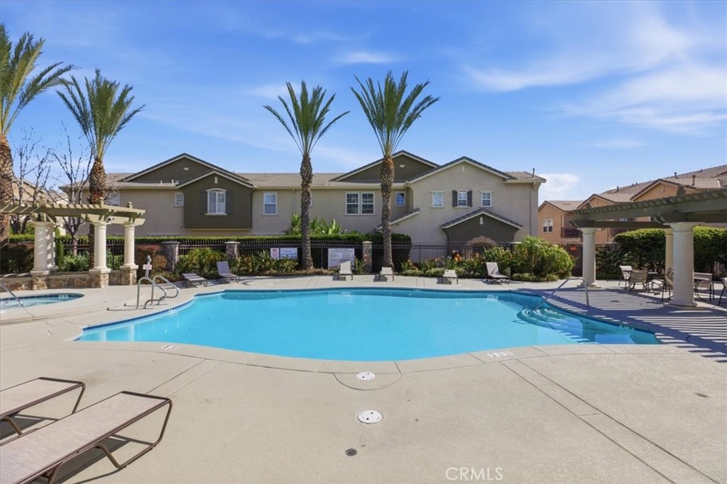 7353 Ellena West, Unit 70 Rancho Cucamonga, CA 91730 - Photo 39 of 40 a front view of house with yard and swimming pool