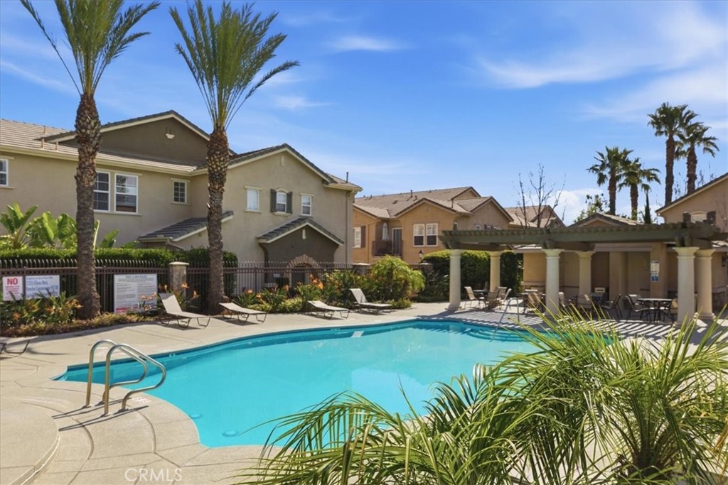 7353 Ellena West, Unit 70 Rancho Cucamonga, CA 91730 - Photo 40 of 40 a front view of a house with garden and sitting area