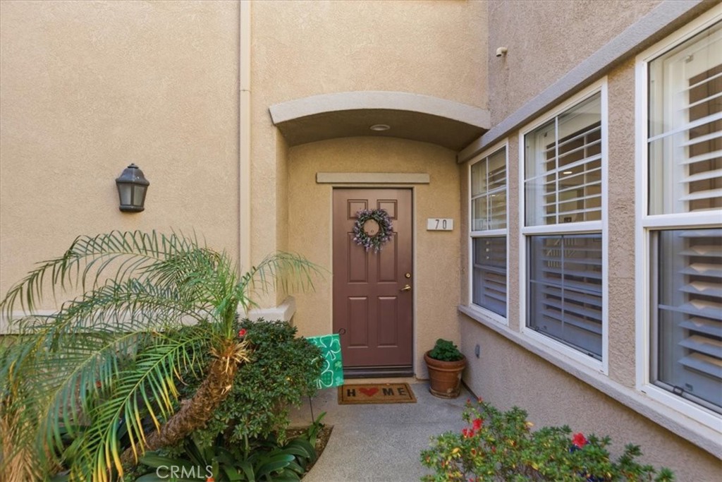 7353 Ellena West, Unit 70 Rancho Cucamonga, CA 91730 - Photo 4 of 40 a front view of a house with a yard