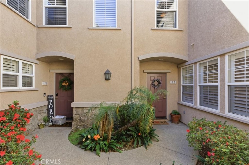 7353 Ellena West, Unit 70 Rancho Cucamonga, CA 91730 - Photo 5 of 40 a front view of a house with a yard