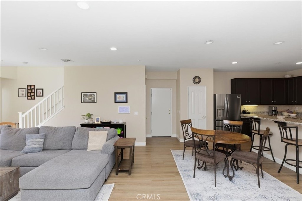 7353 Ellena West, Unit 70 Rancho Cucamonga, CA 91730 - Photo 7 of 40 a living room with furniture a rug and a flat screen tv