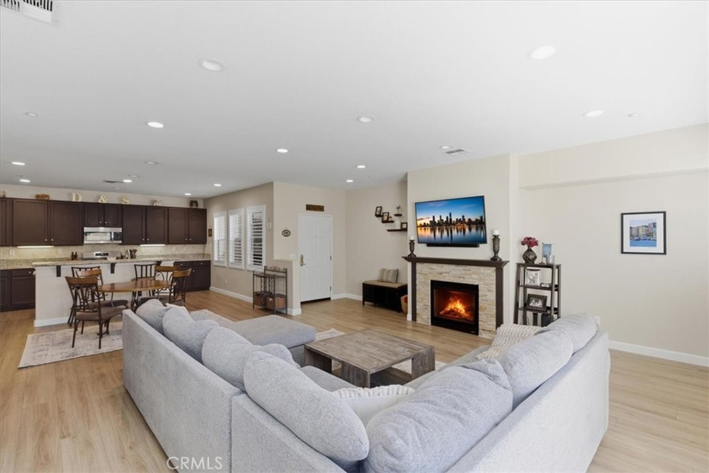 7353 Ellena West, Unit 70 Rancho Cucamonga, CA 91730 - Photo 9 of 40 a living room with furniture and a fireplace