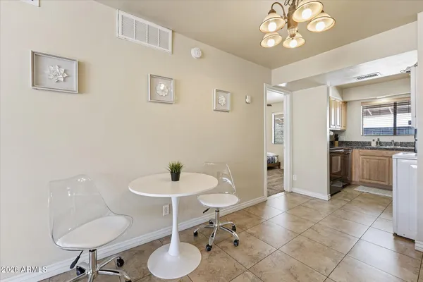 a kitchen with a table and chairs in it