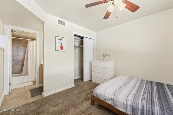 a bedroom with a bed and a window