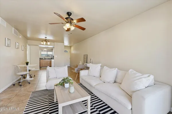 a living room with furniture and a chandelier