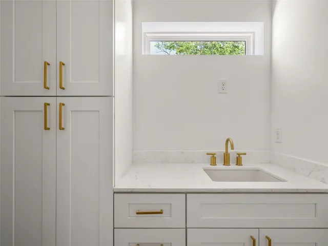 a bathroom with a sink and a window