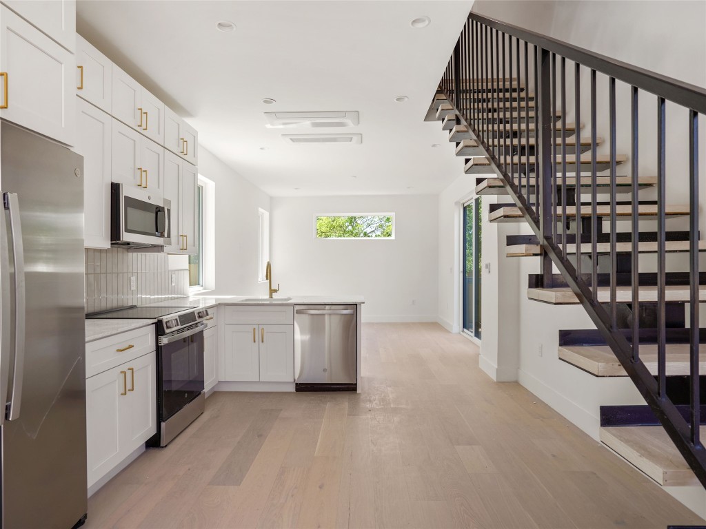 2609 Davis Lane, Unit 2 Austin, TX 78748 - Photo 4 of 26 a kitchen with stainless steel appliances granite countertop a refrigerator and a sink