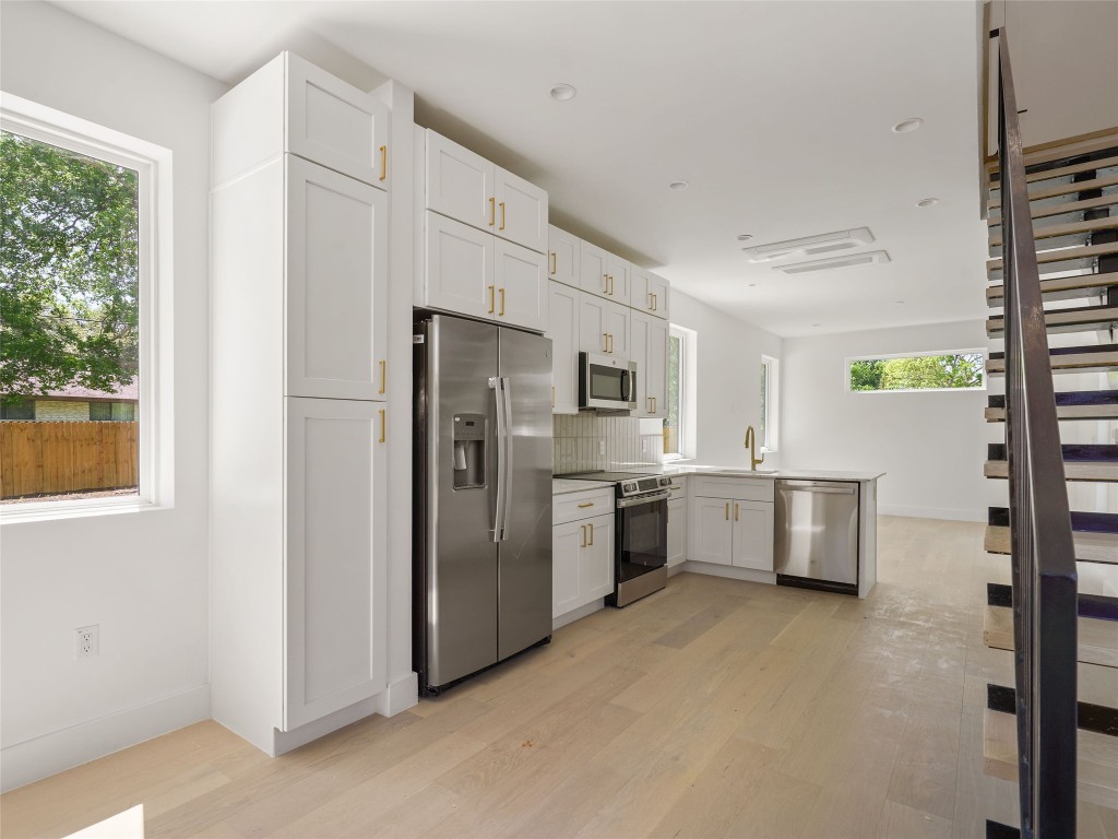 2609 Davis Lane, Unit 2 Austin, TX 78748 - Photo 5 of 26 a kitchen with stainless steel appliances a refrigerator sink and stove