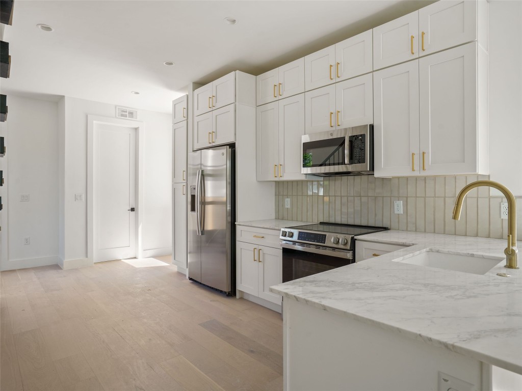 2609 Davis Lane, Unit 2 Austin, TX 78748 - Photo 6 of 26 a kitchen with a stove a refrigerator and a sink