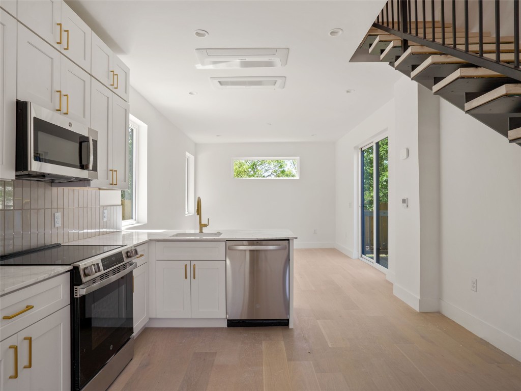 2609 Davis Lane, Unit 2 Austin, TX 78748 - Photo 9 of 26 a kitchen with stainless steel appliances granite countertop a sink and a stove