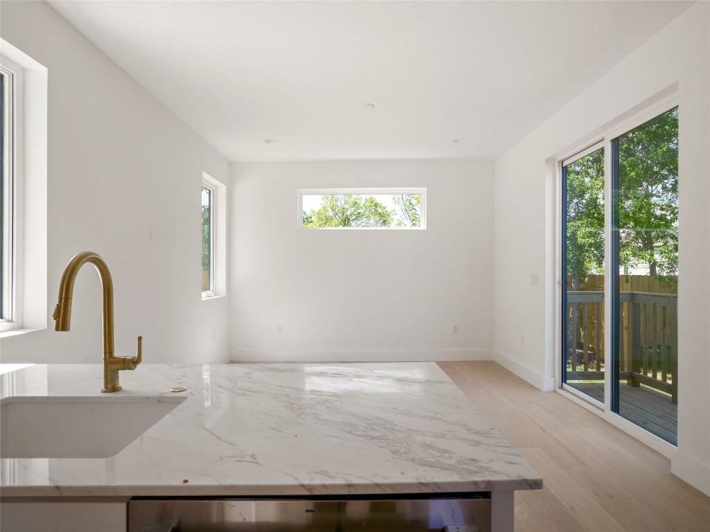 2609 Davis Lane, Unit 2 Austin, TX 78748 - Photo 10 of 26 a view of wooden floor and a sink in a room