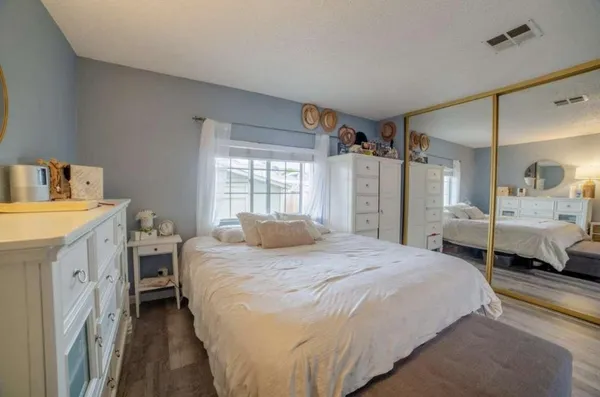 a spacious bedroom with a bed and a large window