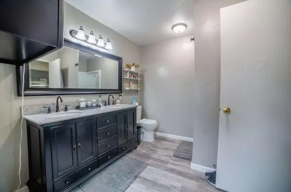 a bathroom with a double vanity sink and a mirror