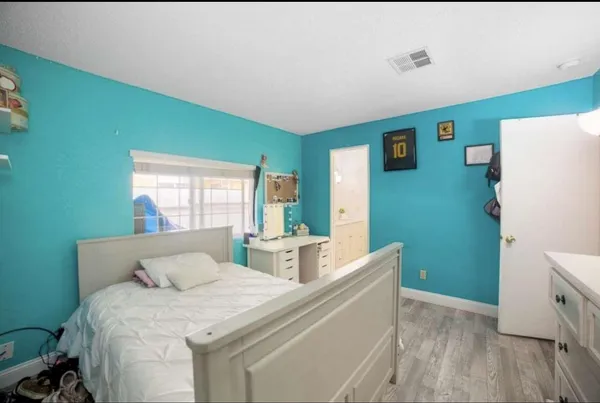 a bedroom with a bed and a dresser