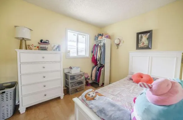 a bedroom with a bed and a closet