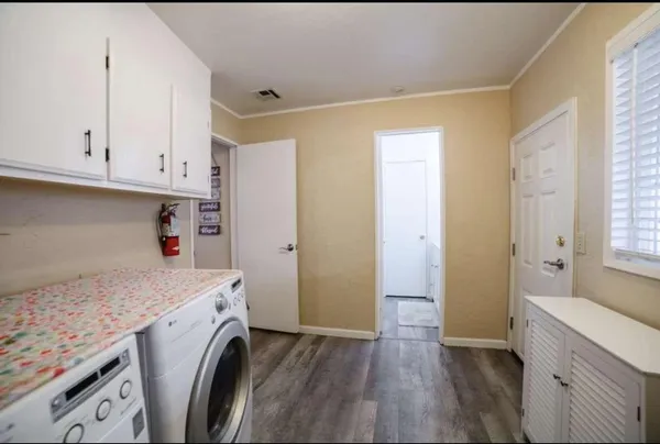 a utility room with cabinets washer and dryer