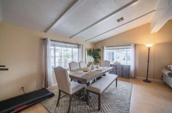 a dining room with furniture and wooden floor