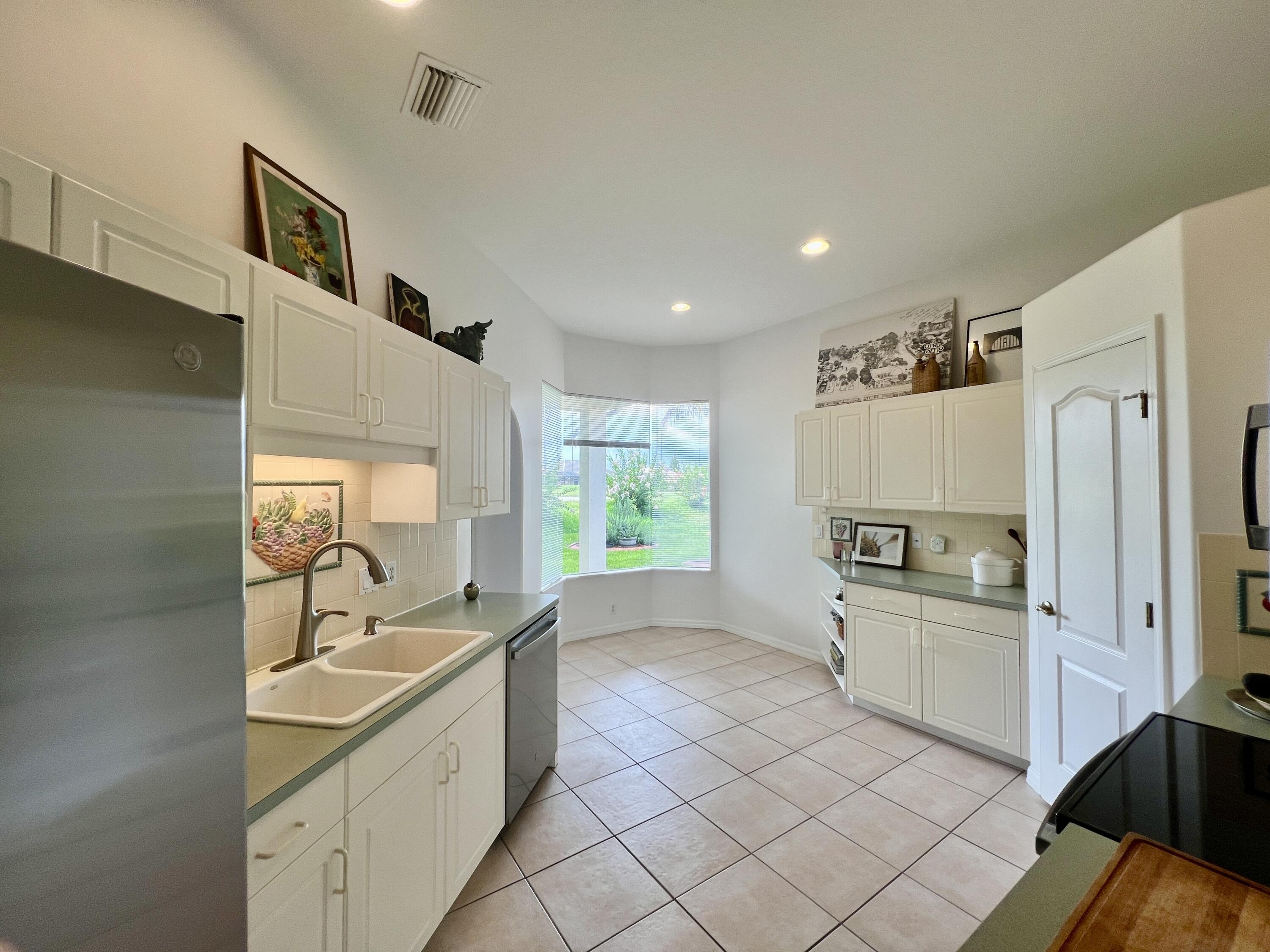 7951 Daventry Drive Melbourne, FL 32940 - Photo 11 of 46 a kitchen with stainless steel appliances a sink a stove a refrigerator and cabinets