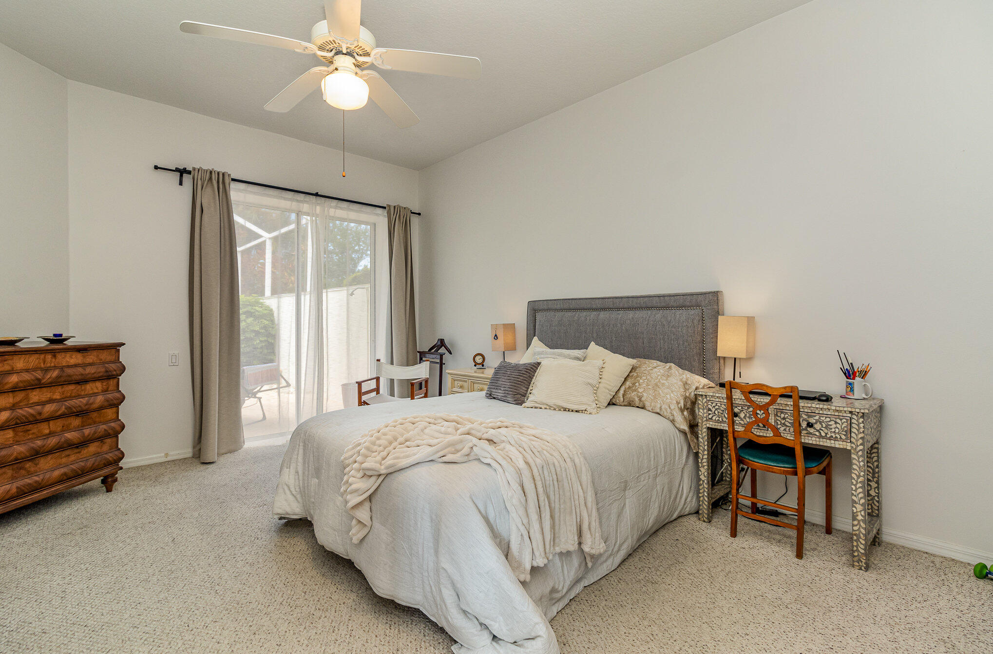 7951 Daventry Drive Melbourne, FL 32940 - Photo 19 of 46 a bedroom with a bed and a chandelier