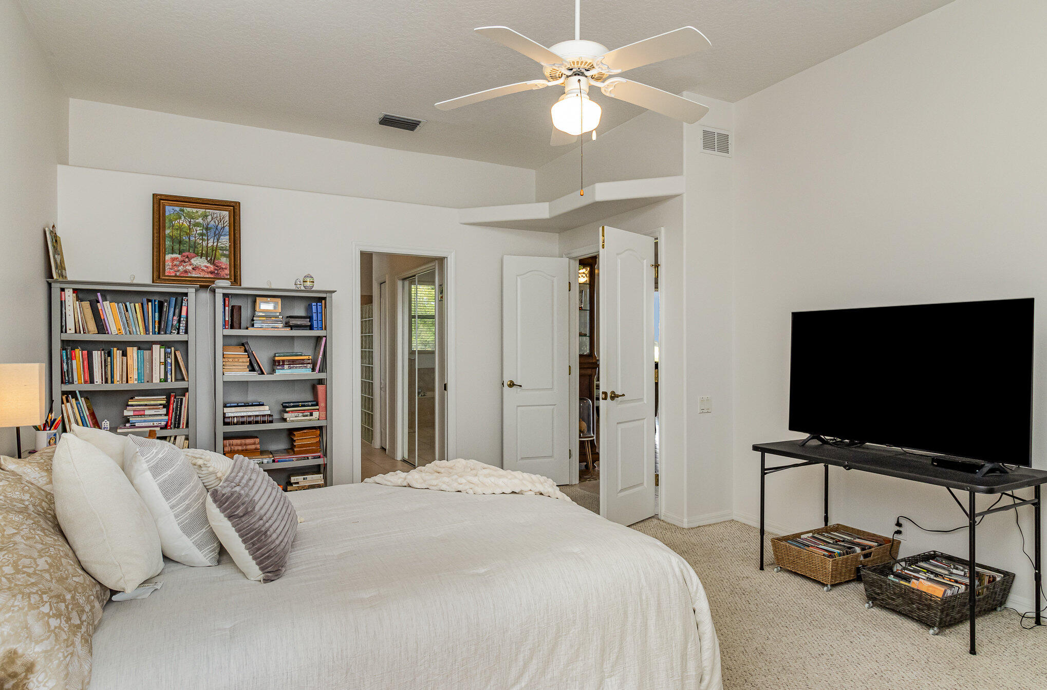 7951 Daventry Drive Melbourne, FL 32940 - Photo 21 of 46 a bedroom with a bed and a flat screen tv