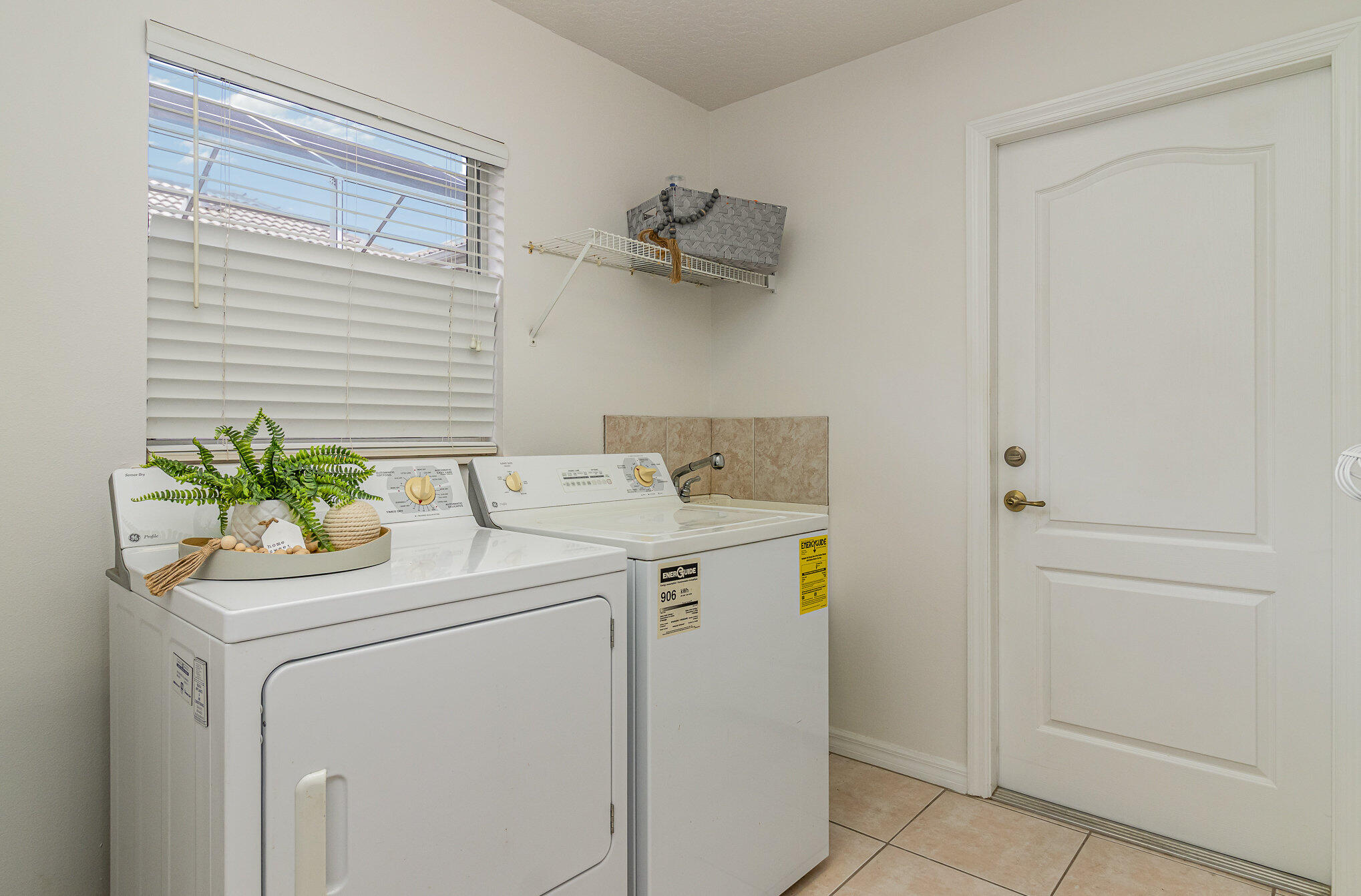 7951 Daventry Drive Melbourne, FL 32940 - Photo 30 of 46 a utility room with dryer and washer