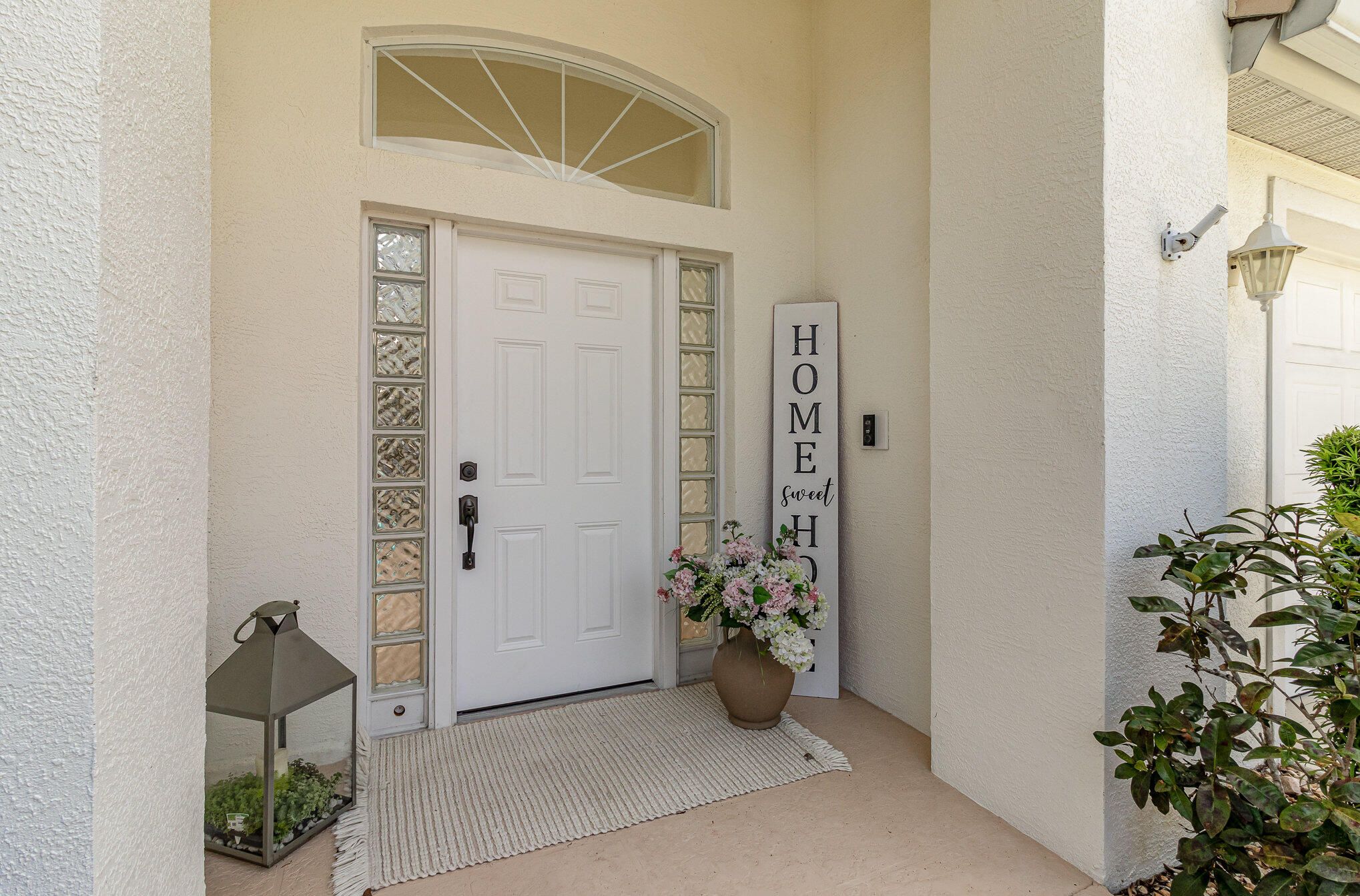 7951 Daventry Drive Melbourne, FL 32940 - Photo 33 of 46 an entryway with a flower pot and a potted plant