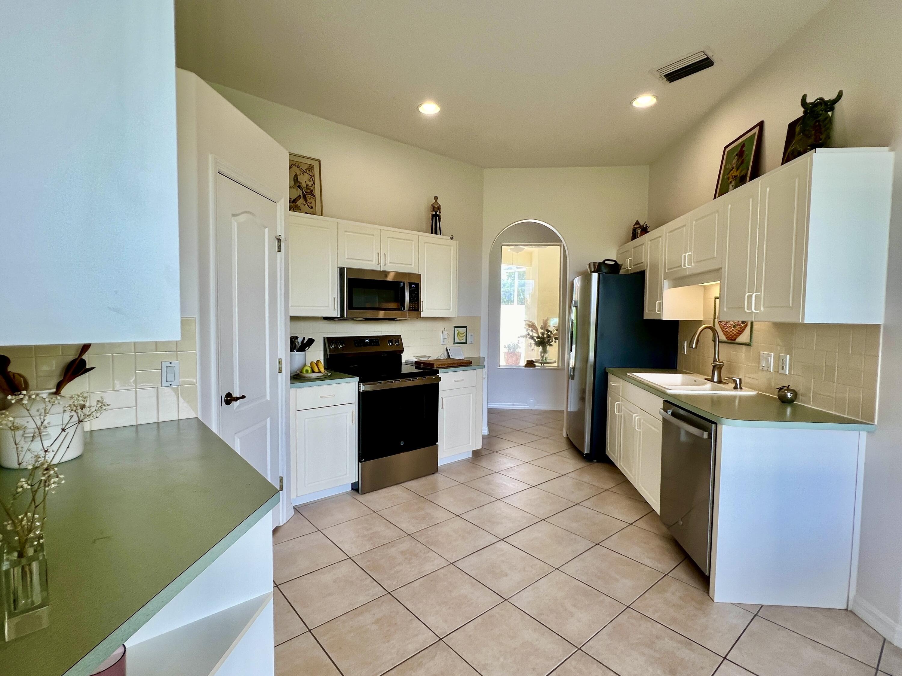7951 Daventry Drive Melbourne, FL 32940 - Photo 4 of 46 a large kitchen with a sink stainless steel appliances and cabinets