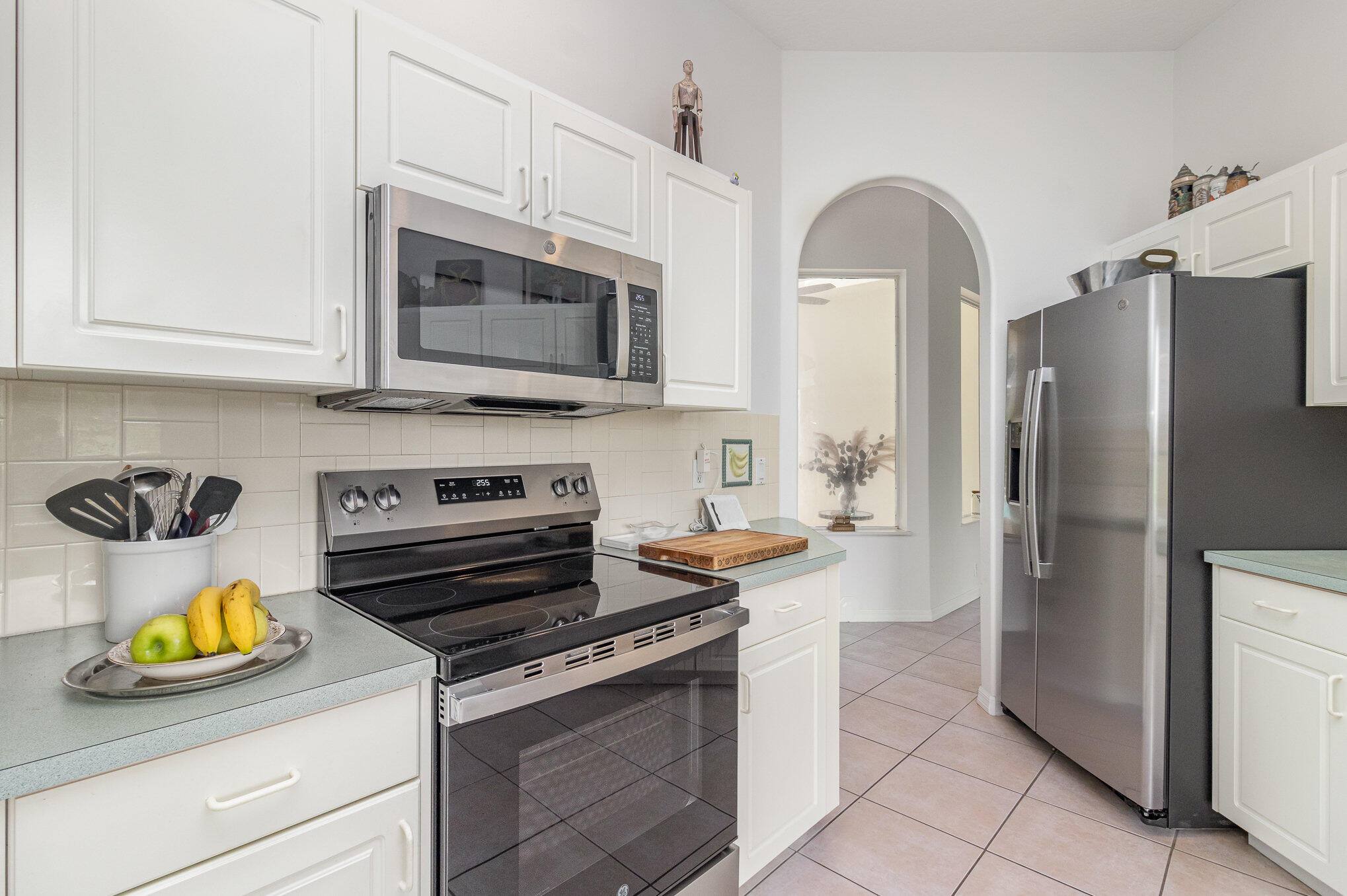 7951 Daventry Drive Melbourne, FL 32940 - Photo 6 of 46 a kitchen with stainless steel appliances granite countertop a stove a refrigerator and a white cabinets