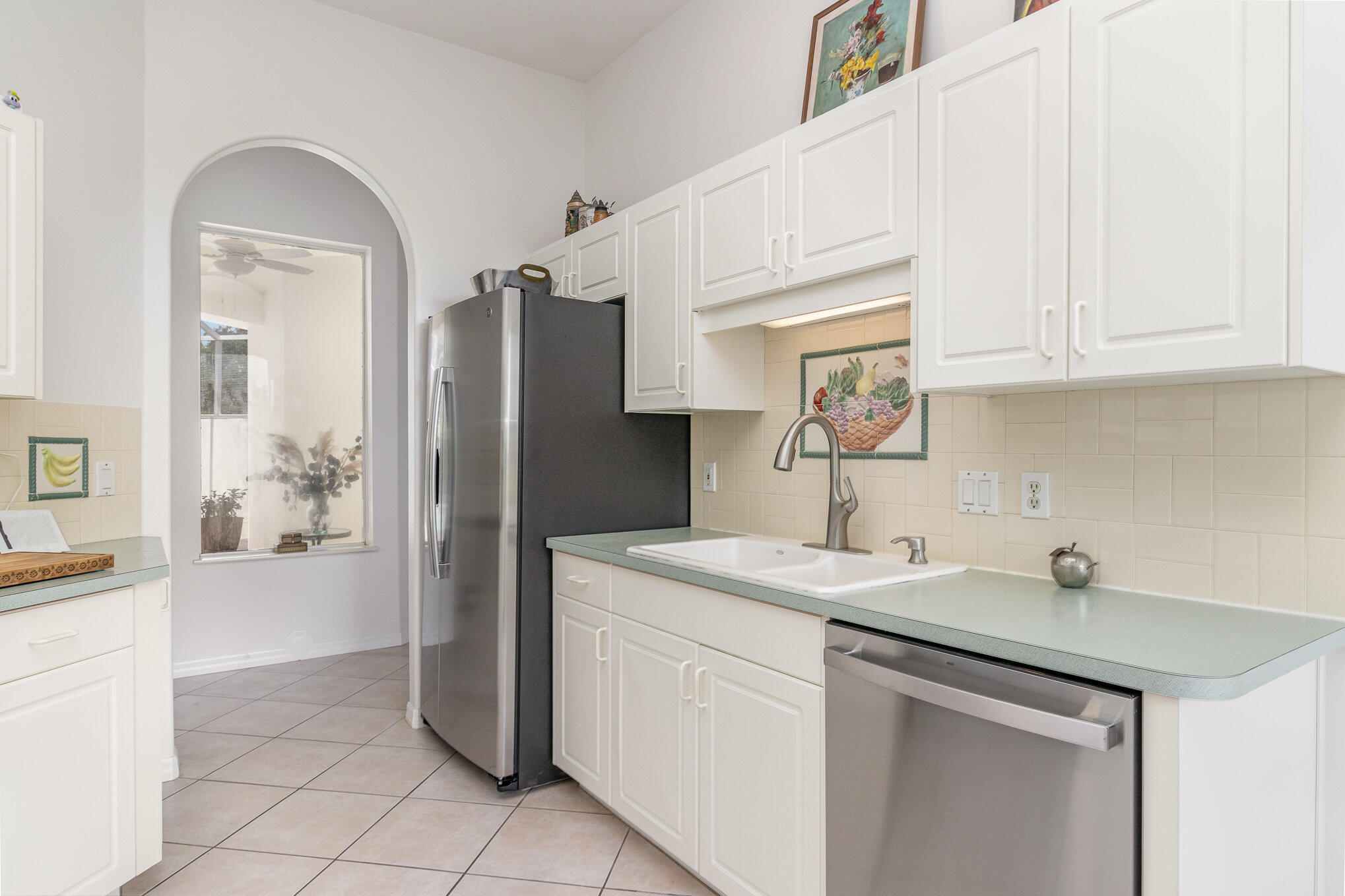 7951 Daventry Drive Melbourne, FL 32940 - Photo 7 of 46 a kitchen with a sink cabinets and appliances